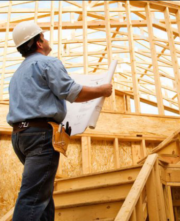 a man in a hard hat standing on a stair case