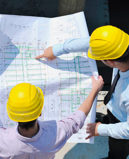 two men looking at a paper of construction estimating and maping