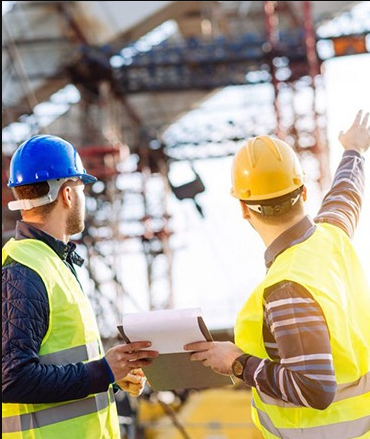 two men standing next to each other and talking about construction